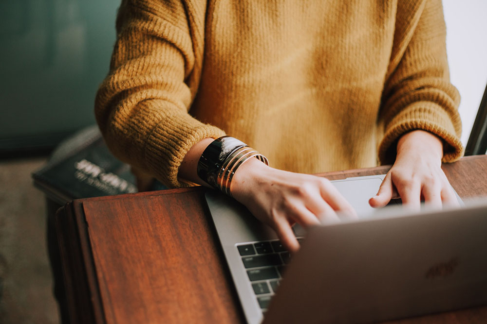 Photo of an employee preparing a presentation on a laptop computer.